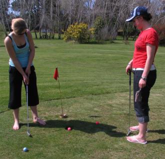 Jane Soper watching Estelle Baker putting